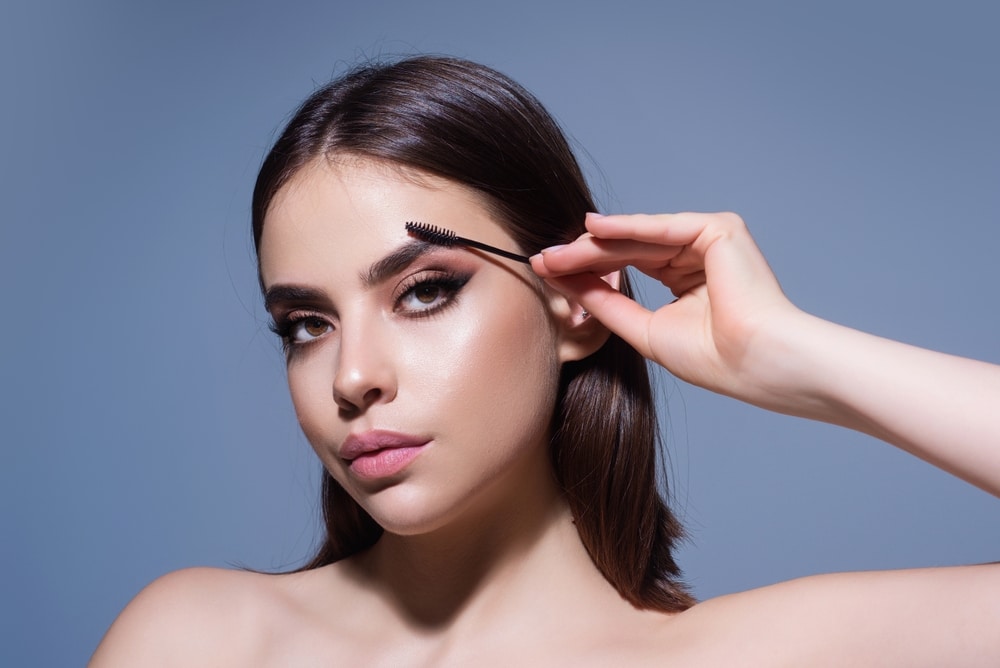 Beautiful Woman With Dark Eyebrows Hold Eyebrow Brush 