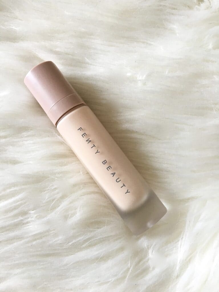 fenty beuaty primer placed on a fluffy fabric