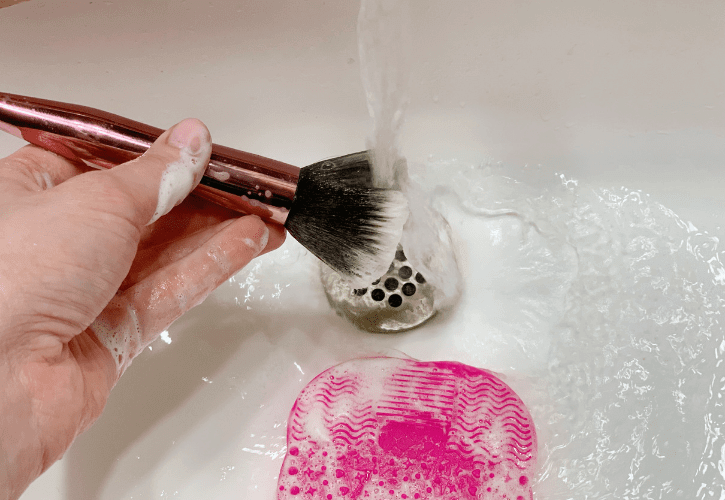 rinsing a makeup brush