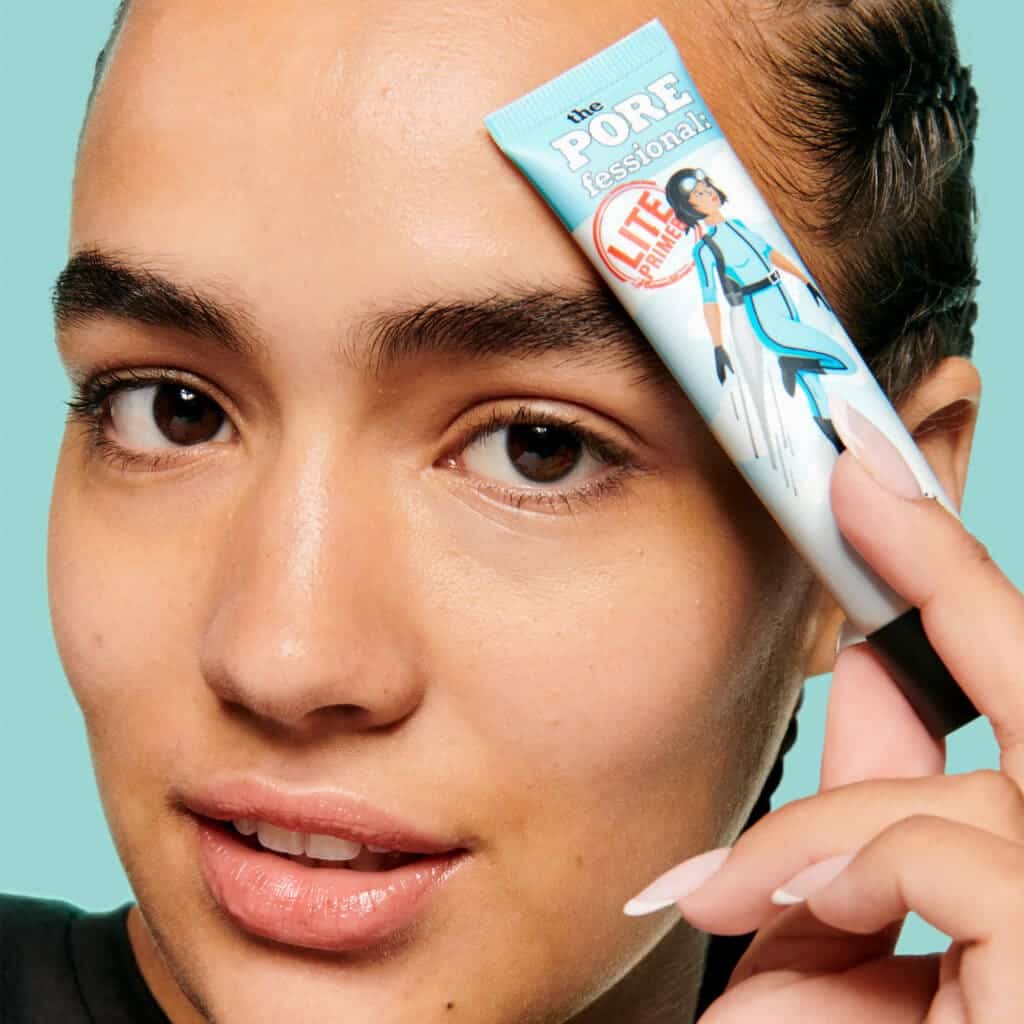 zoomed in view of agirls face holding porefessional primer