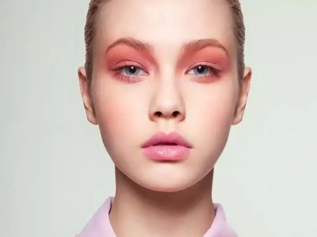 zoomed view of coral pink makeup on eyescheeks and lips