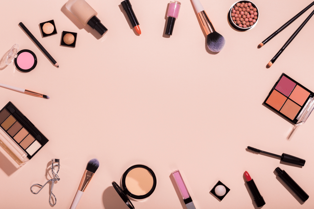 Frame of make up professional products on pink background