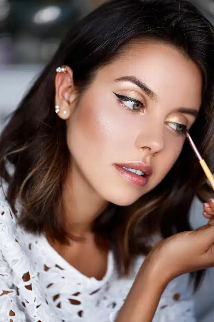 a girl applying eye makeup