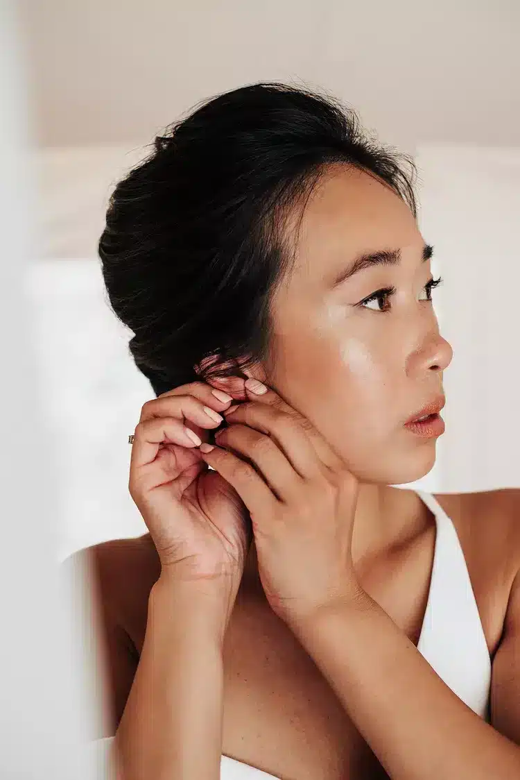 side face of a bride with wedding makeup in rosy gold and bronze