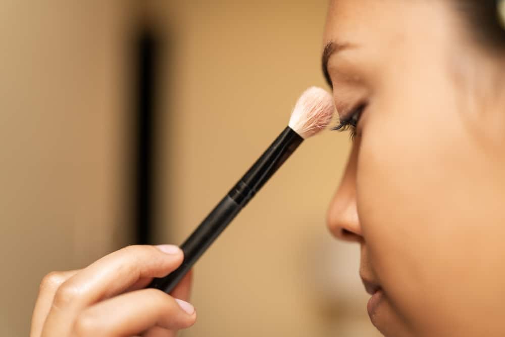 Makeup Artist Is Applying Eyeshadow To A Model's Face In