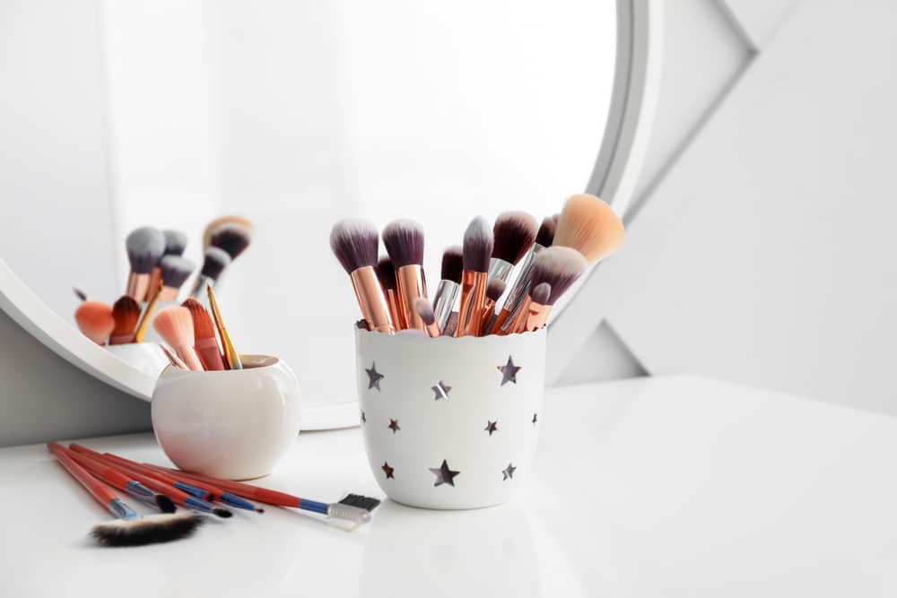 Set Of Makeup Brushes in a cup On Dressing Table