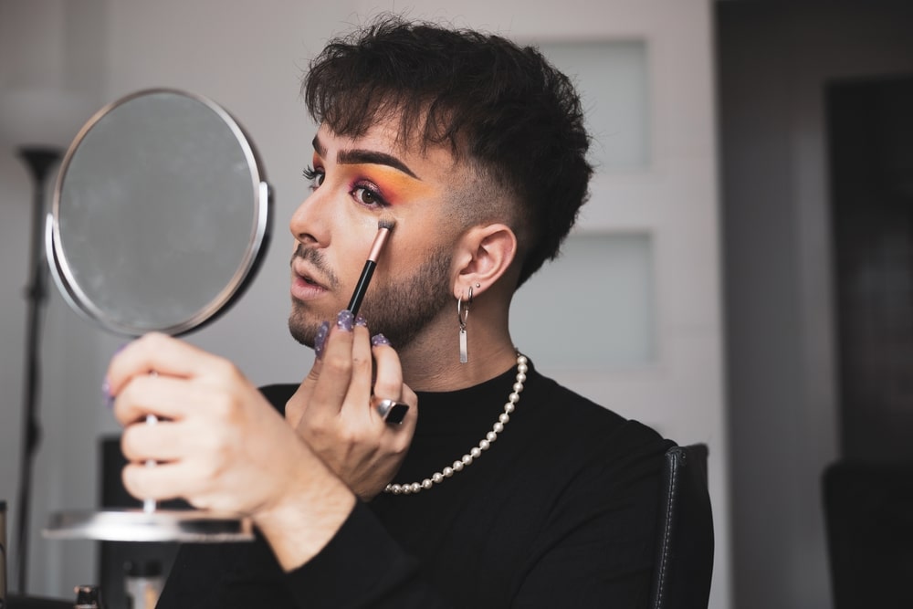 A view of a man wearing makeup