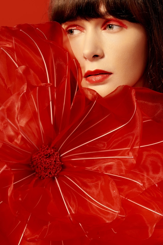 A view of a woman wearing a monchromatic red makeup