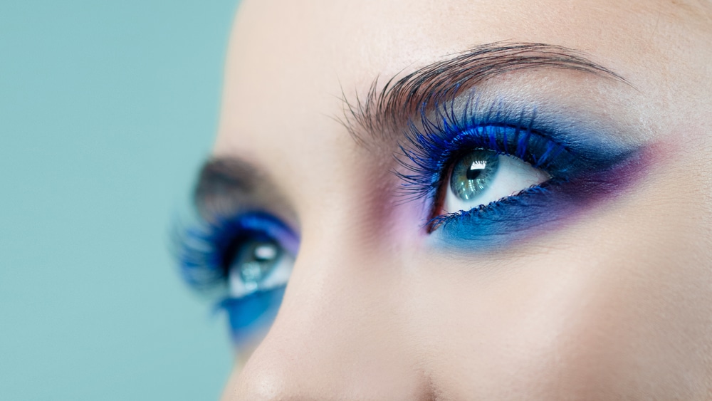 A view of eyes wearing a colorful mascara